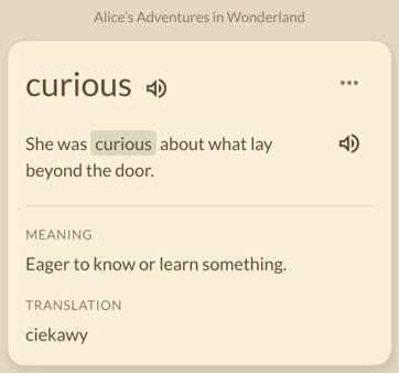 A built-in review card showing curious in its original sentence, with its meaning and translation